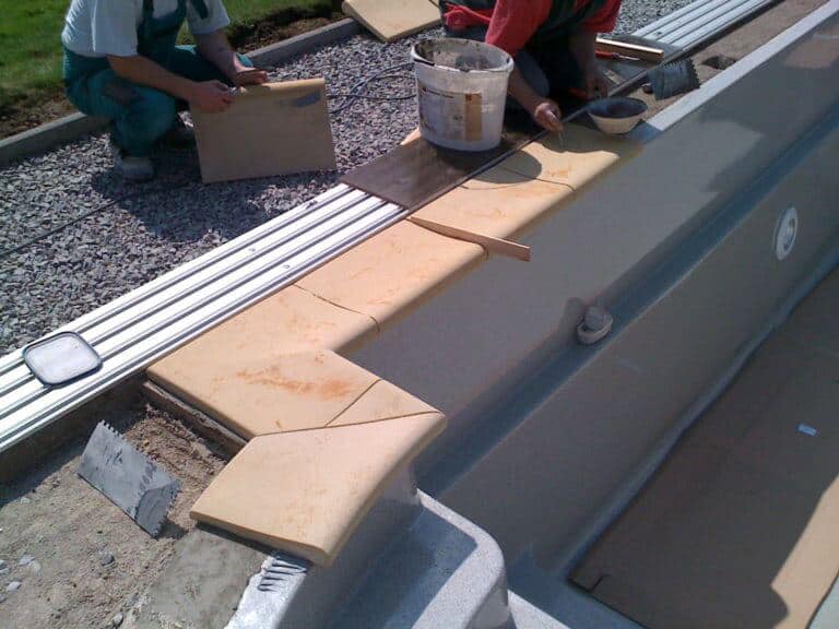 Laying the tiles around the JAVA pool 