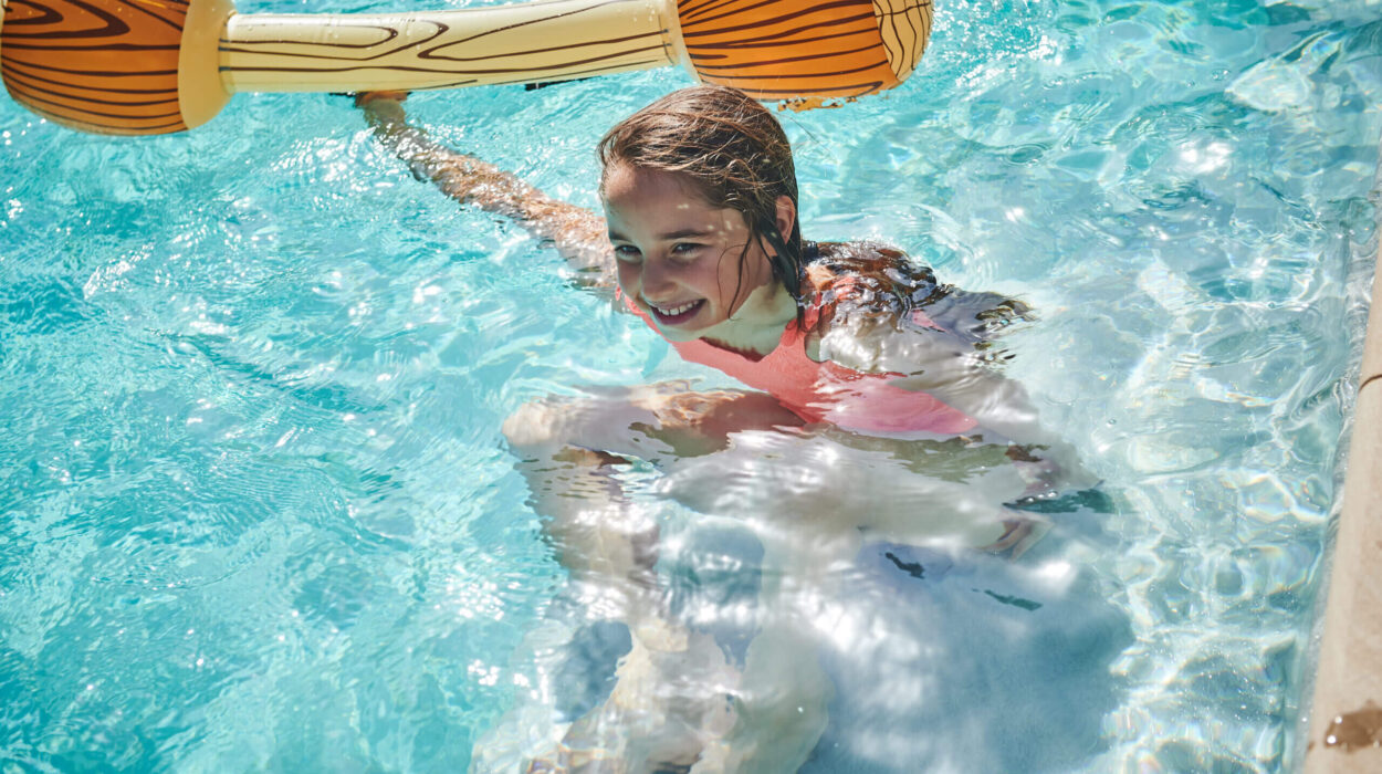 Child in pool with float